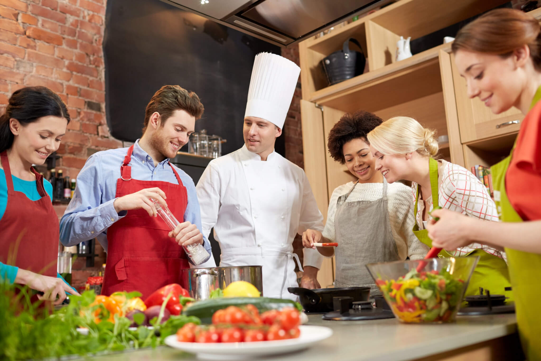cooking class culinary food people concept happy group friends male chef cook cooking kitchen scaled