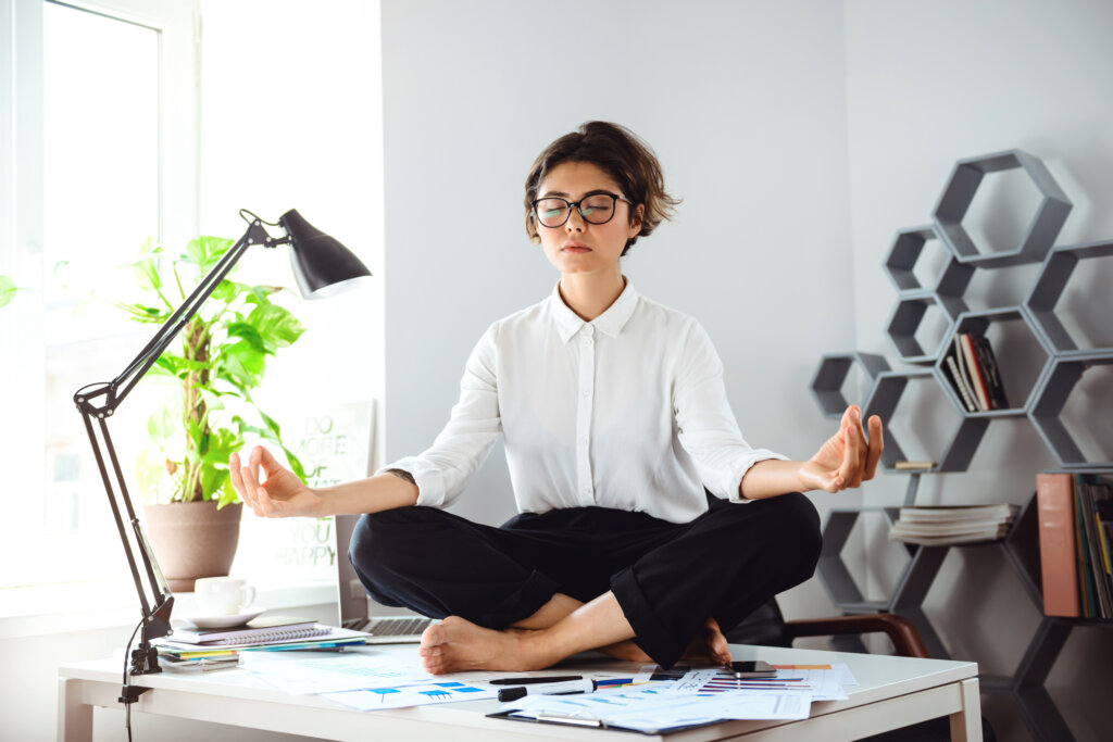 young beautiful businesswoman meditating table workplace office