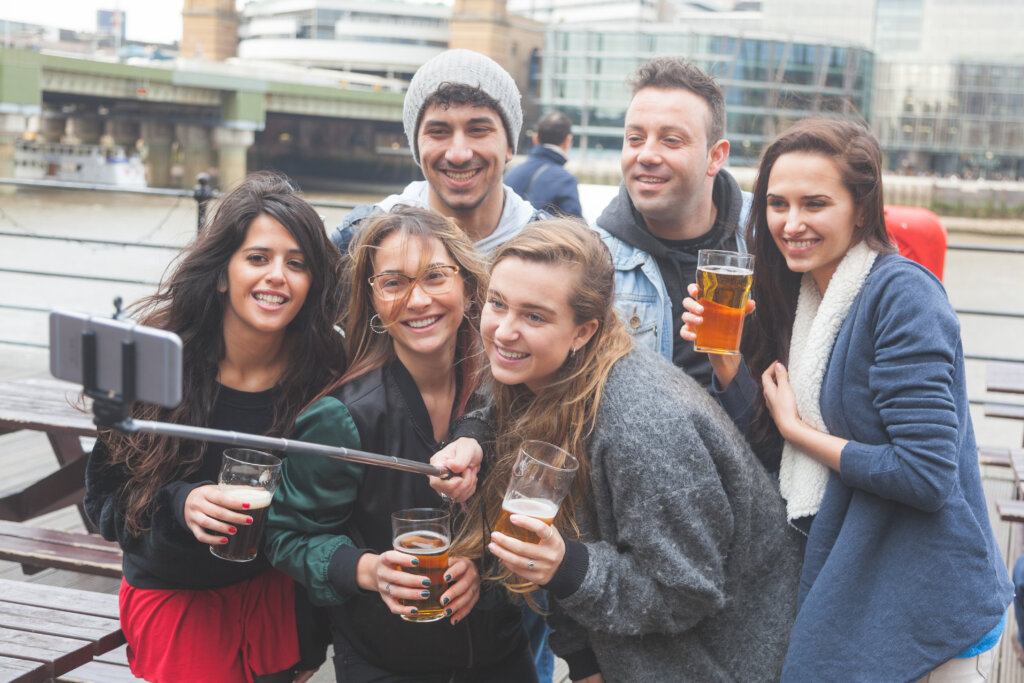 group friends taking selfie pub london